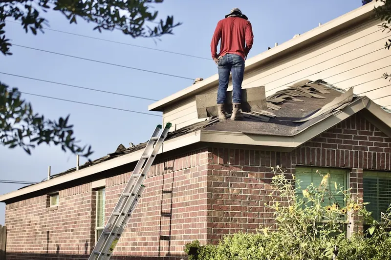 Professional roofer working on a residential roof in Melissa
